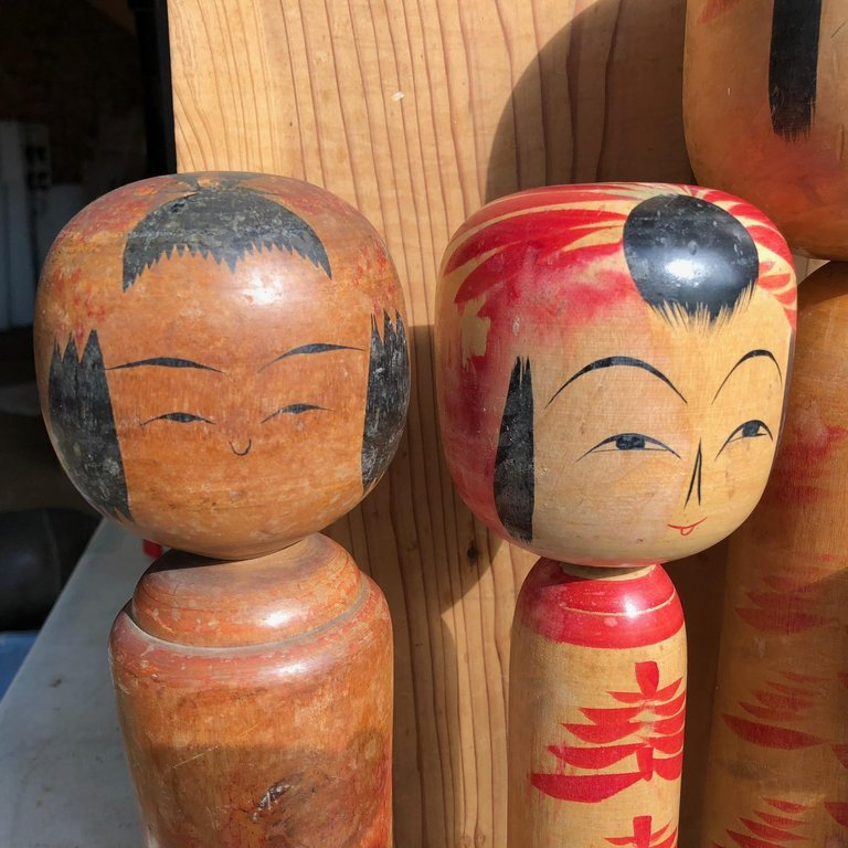 Vintage Japanese pedestal wooden bowl with kokeshi dolls carved and painted on it